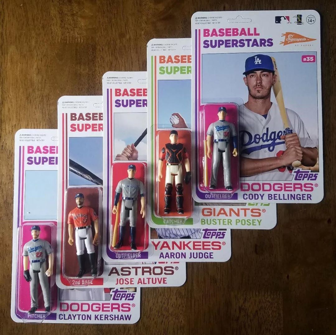 Fan layout of vintage Topps Baseball cardbacks with Cody Bellinger figure and other players in blister packs.