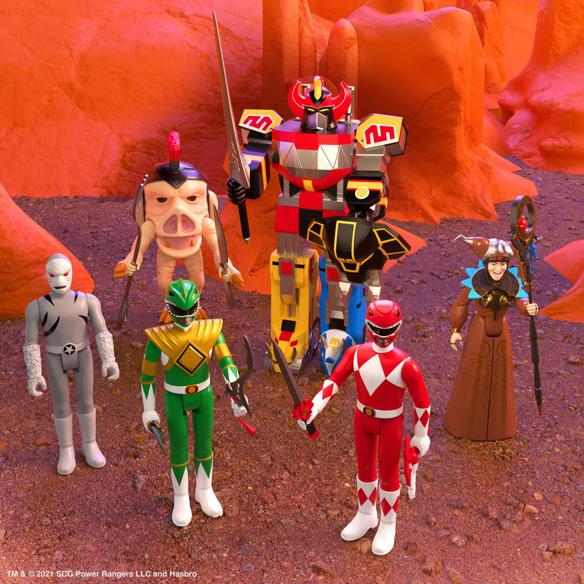 Mighty Morphin Power Rangers ReAction figures posed on a rocky orange landscape with a large Megazord figure looming behind them.