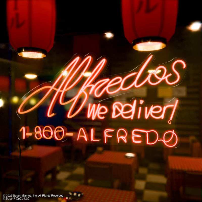 Red neon Alfredos sign reading We deliver 1-800-ALFREDO in a dim dining area.