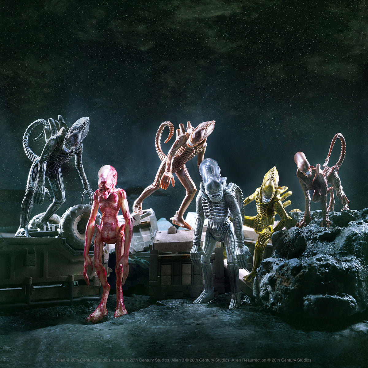 Alien Day 2021 display featuring various Xenomorph figures gathered on a rocky surface under a dark space backdrop.