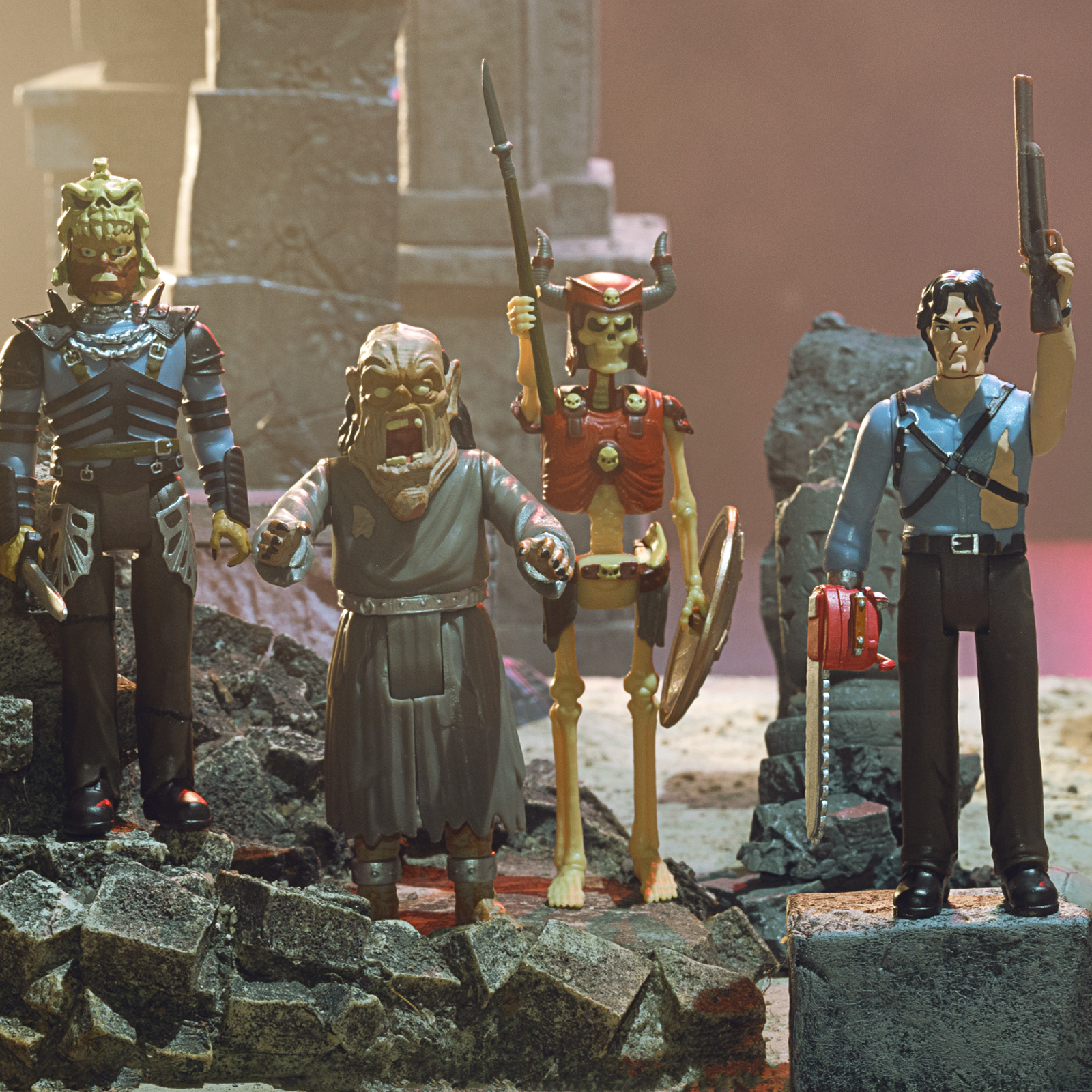 Super7 Army of Darkness action figures posed on a rocky diorama, including Ash with a gun and skeletal warriors