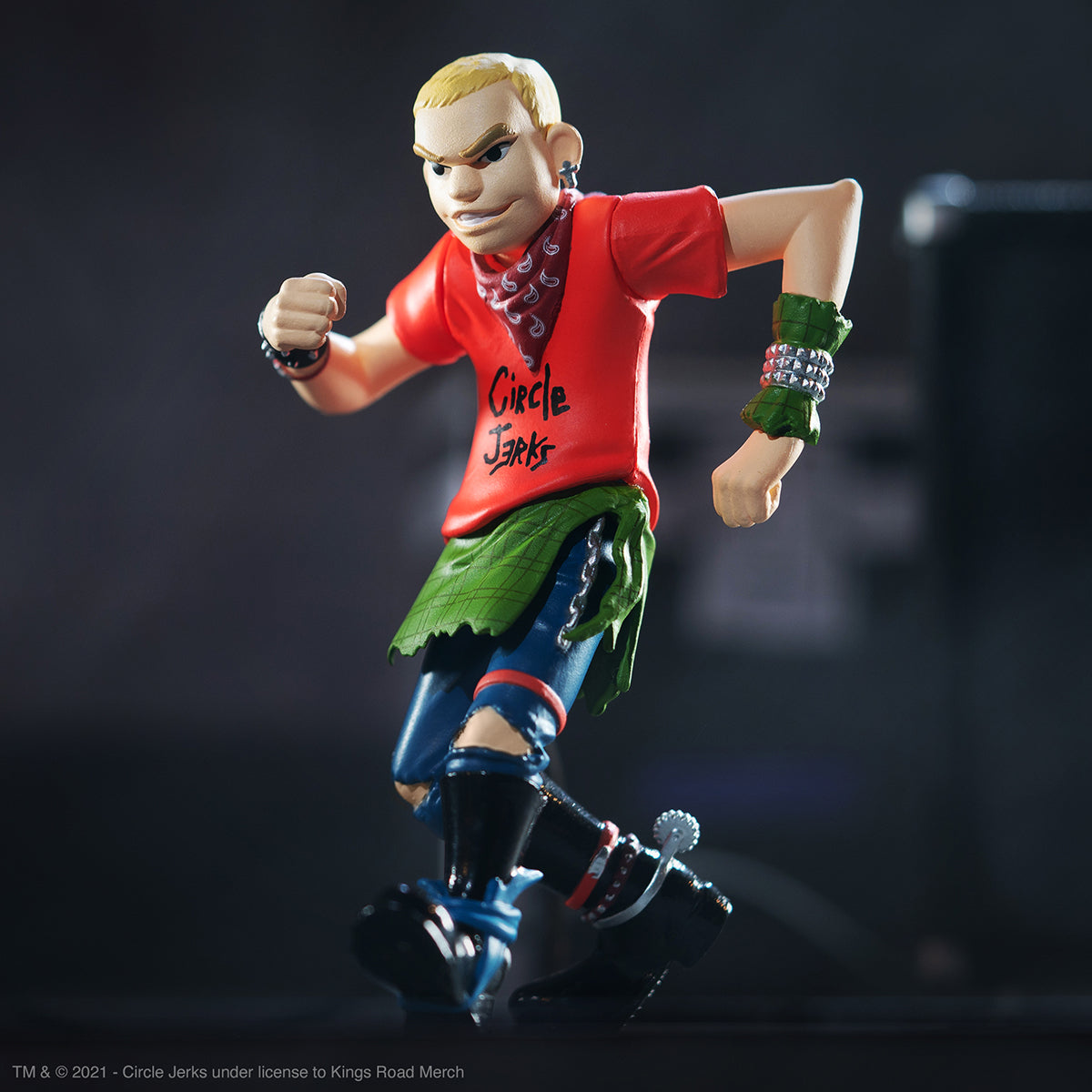 Circle Jerks ReAction figure in red shirt with scarf and studded wristbands posing mid stride