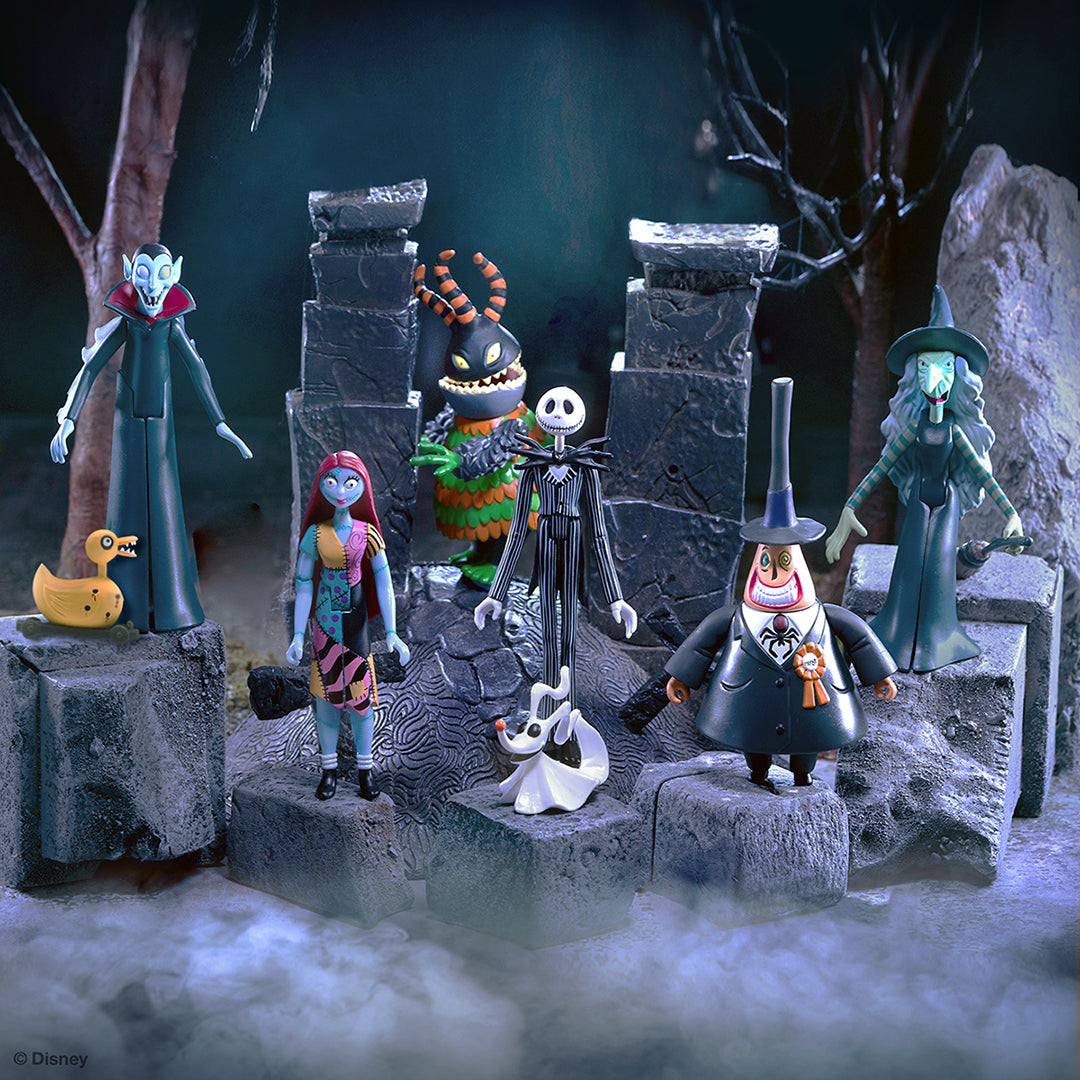 Nightmare Before Christmas character figures arranged on a rocky stage with fog and dim blue lighting