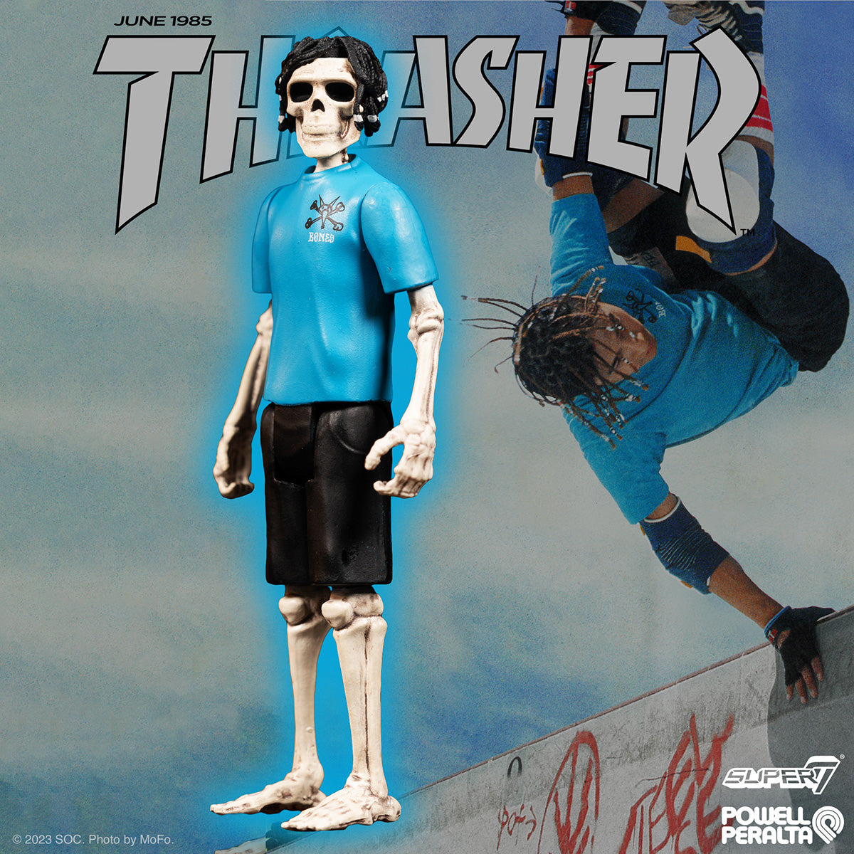 Steve Caballero ReAction figure posed in front of a Thrasher magazine cover wearing a blue shirt