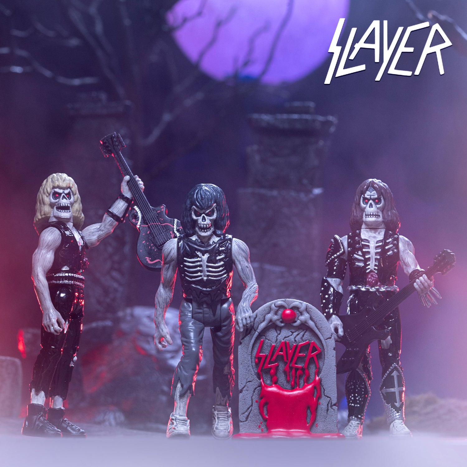 Skeleton and undead figures with guitars on a stage in a Slayer tribute scene with a Slayer logo visible on a tombstone prop