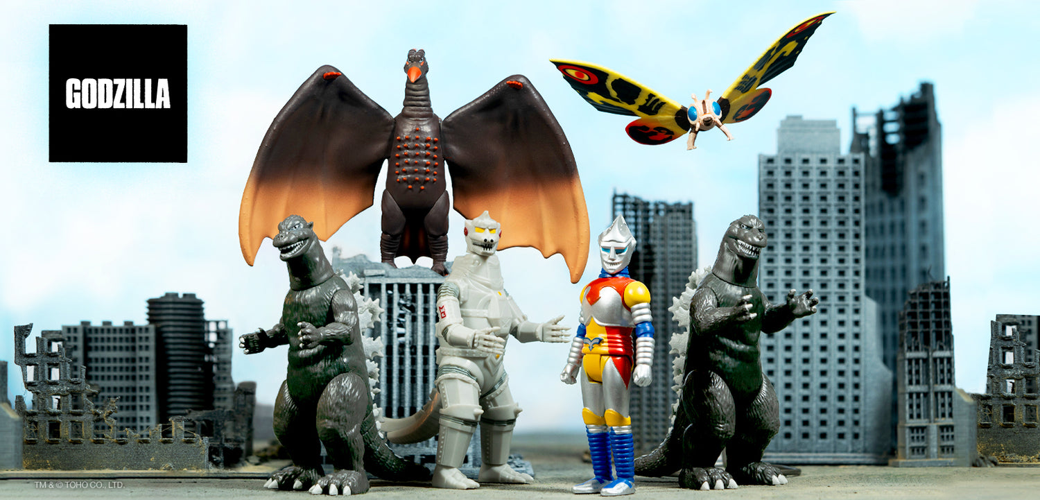 Toho Wave 1 ReAction Figures lineup featuring Godzilla and fellow kaiju assembled in front of a city backdrop.