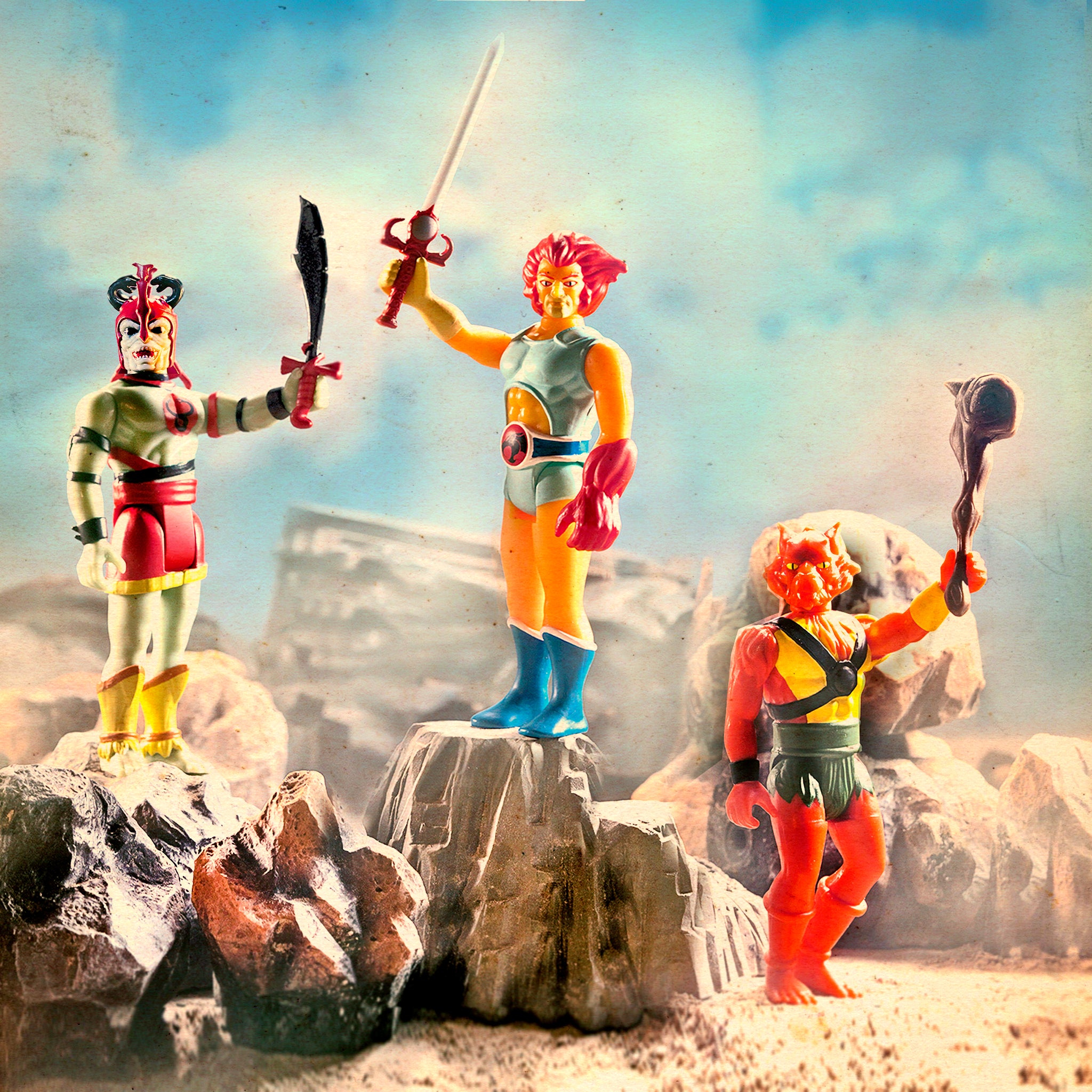 ThunderCats ReAction figures posed on a rocky outcrop with swords in hand