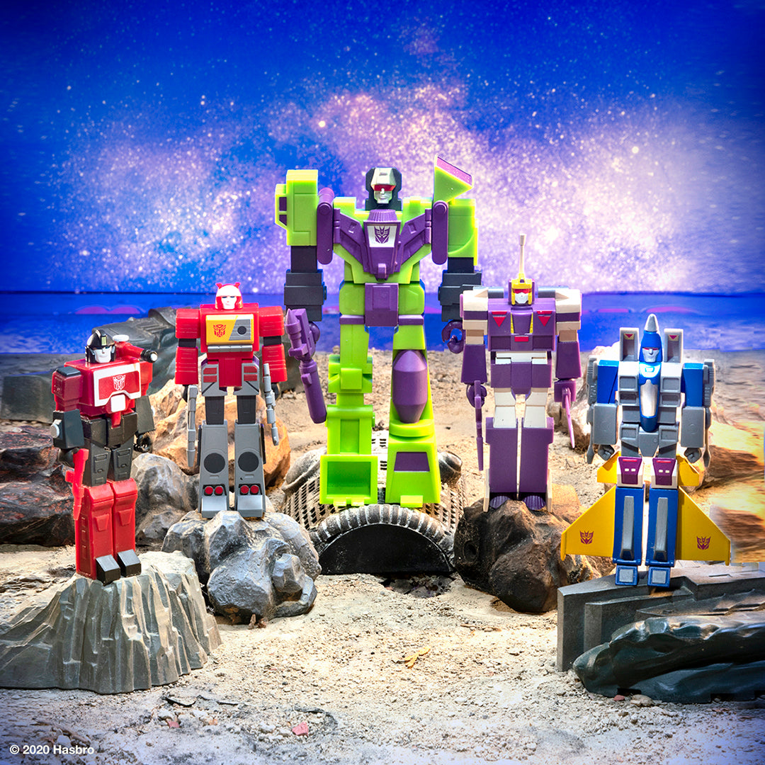 New Transformers ReAction figures wave 3 lineup posed on rocky lunar surface with starry sky