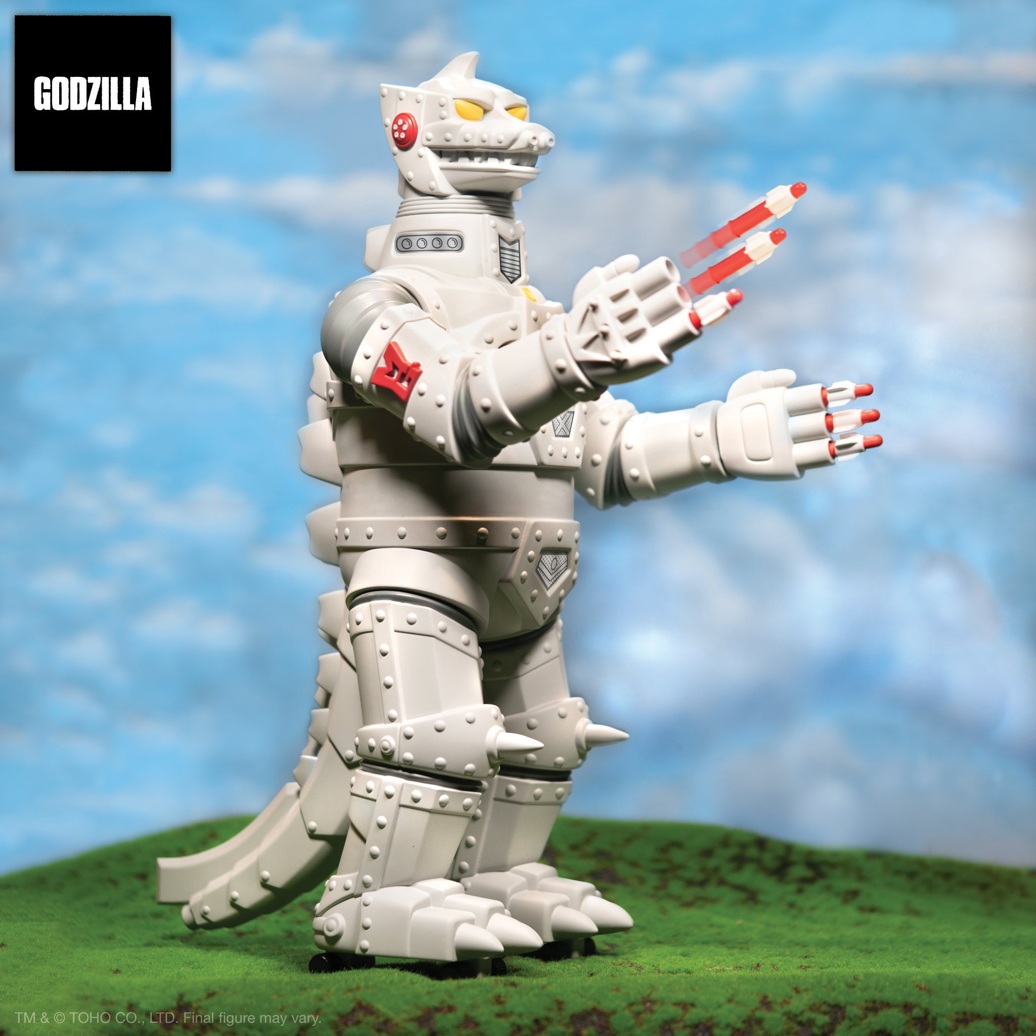 Toho Super Shogun Mechagodzilla action figure in a grassy field with a blue sky backdrop.