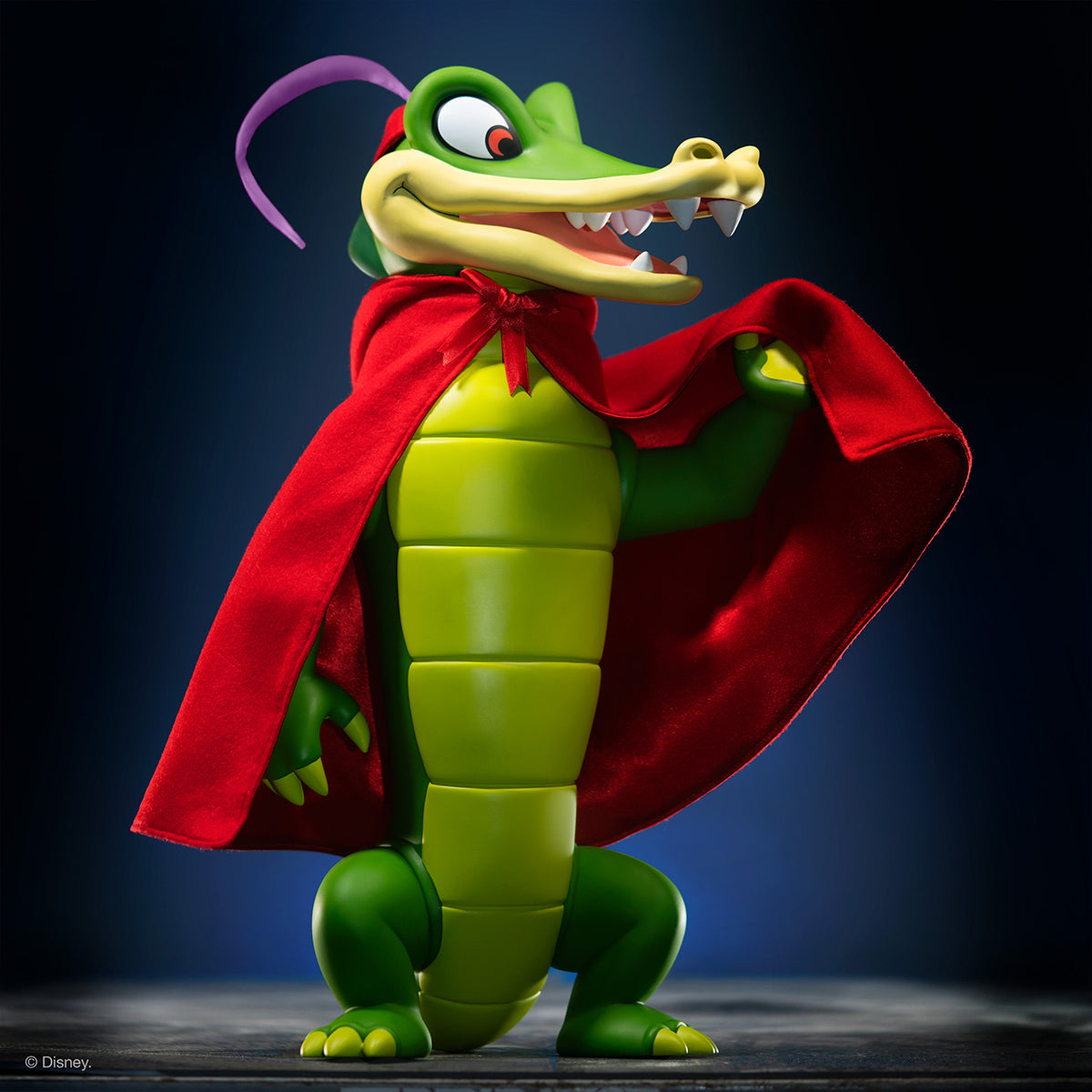 Disney Fantasia supersize Ben Ali Gator figure in a red cape against a dark background.