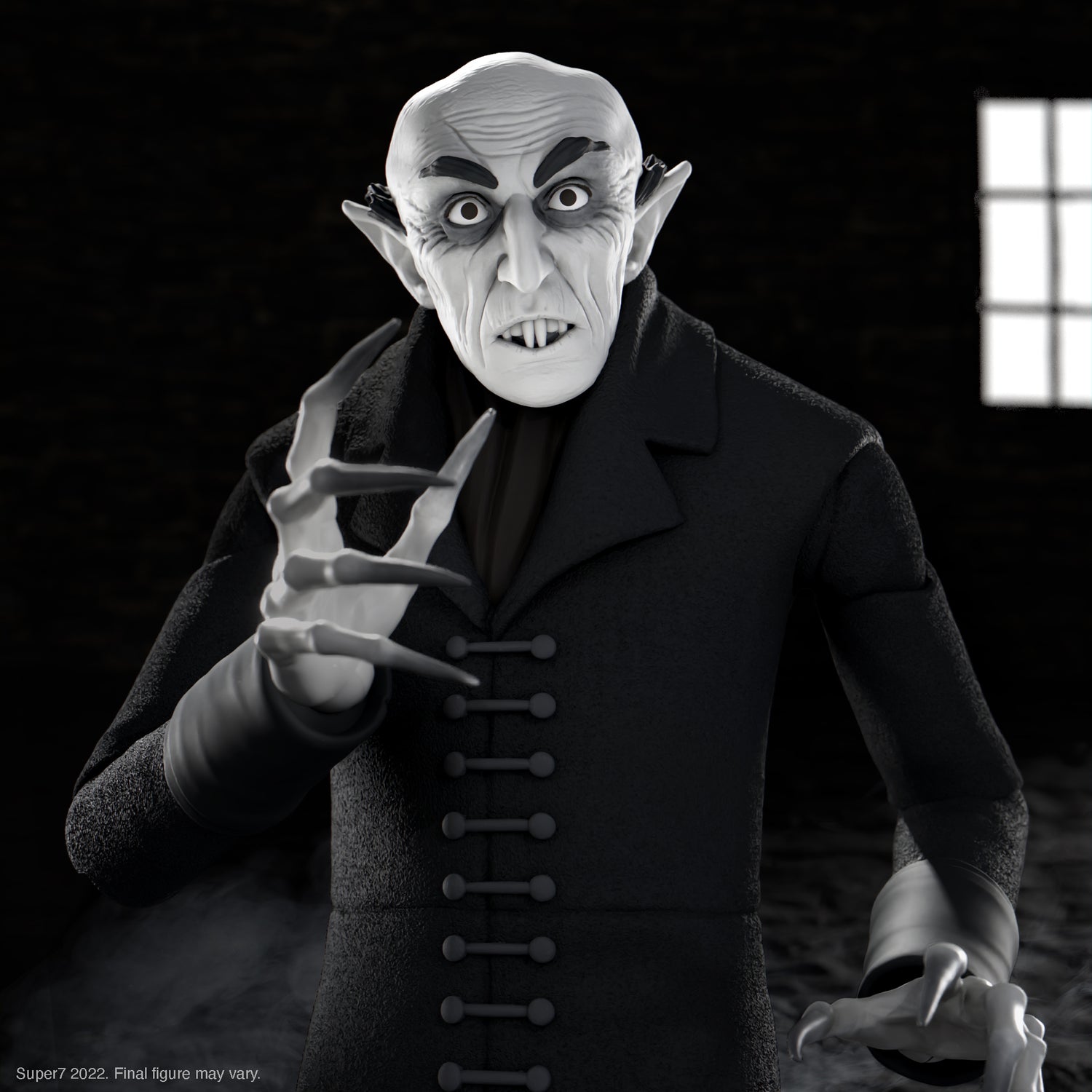 Pale vampire action figure with pronounced fangs and black cape against a dark background.