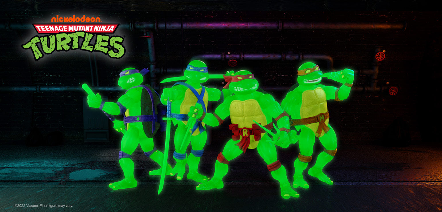 Group of glowing neon green Teenage Mutant Ninja Turtles action figures in a dark setting.