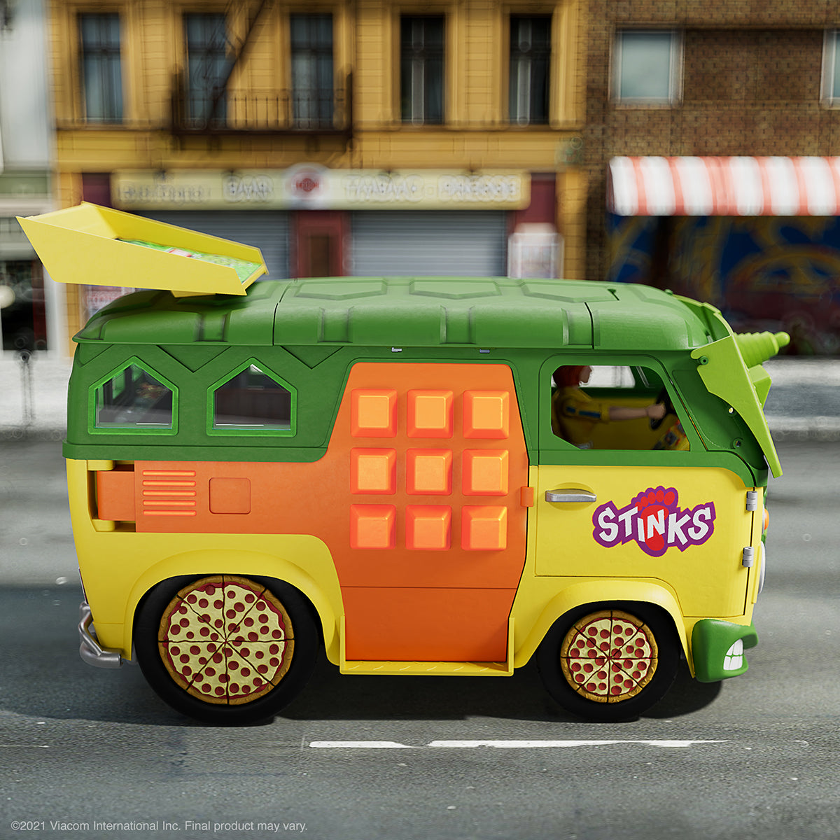 Teenage Mutant Ninja Turtles Party Wagon toy van with bright colors and pizza wheel rims on a city street