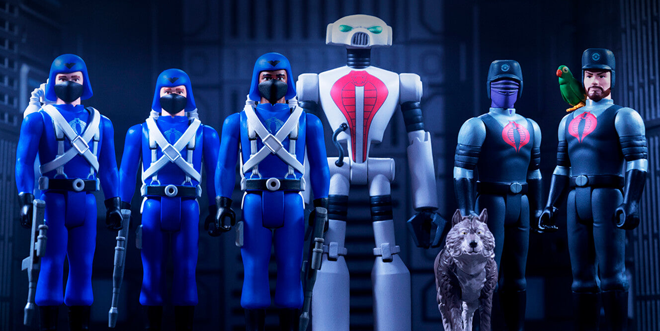 Five Super7 action figures in blue uniforms flank a tall white robot against a blue industrial backdrop