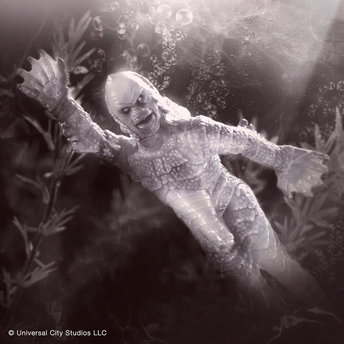 Creature from the Black Lagoon action figure swimming underwater among bubbles.