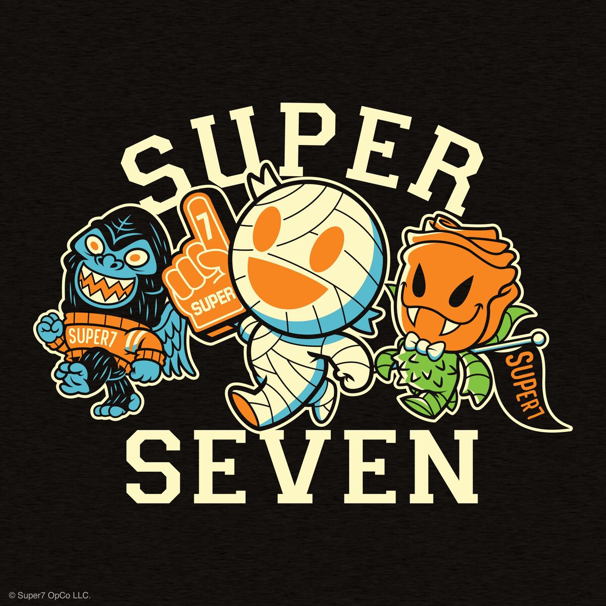 Super Seven graphic tee design shows a mummy monster and pumpkin heroes against a black fabric background with bold SUPER SEVEN text.