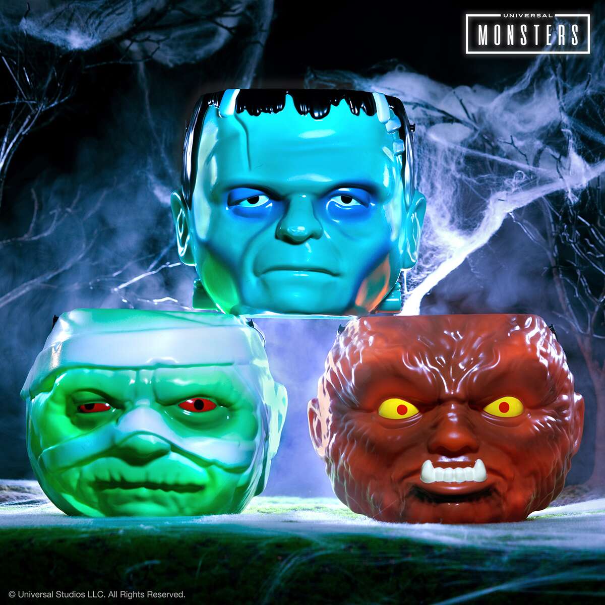 Stacked trio of cartoon monster heads blue green and red from Universal Monsters Superbuckets promo.