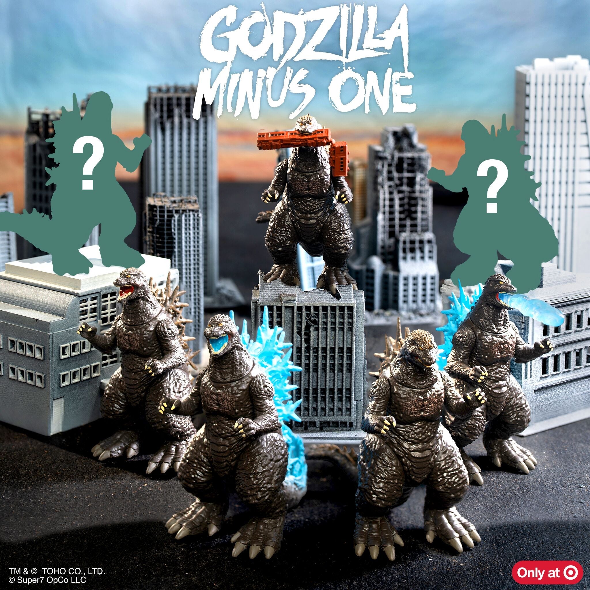 Godzilla figure towers over a toy city with two green silhouettes and question marks on either side