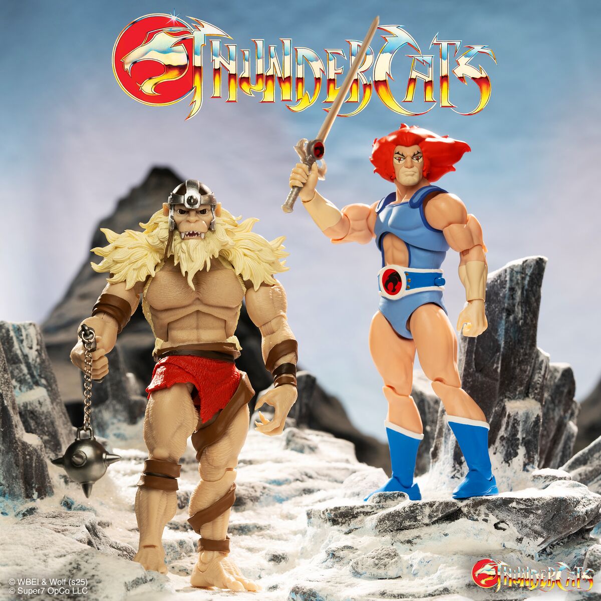 Two ThunderCats action figures posed on a snowy rocky terrain under a large ThunderCats logo
