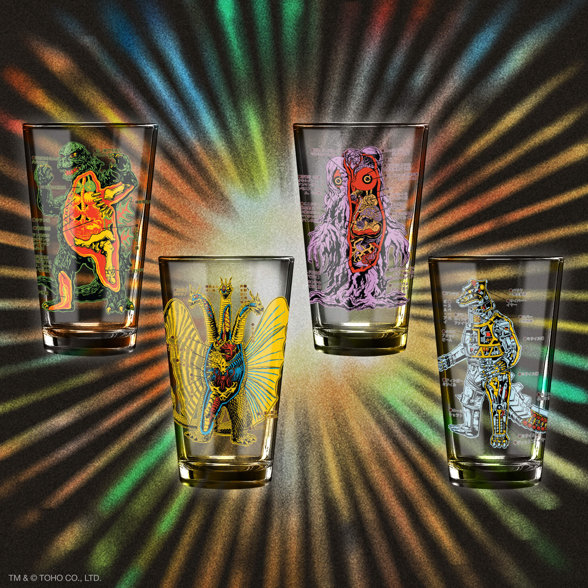 Assorted glasses with bright monster artwork printed on clear glass against a dark background