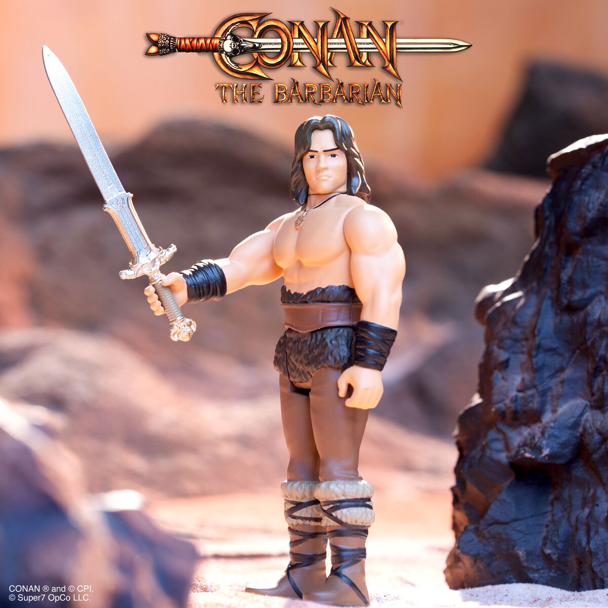 Conan the Barbarian action figure in a desert setting, wielding a sword.