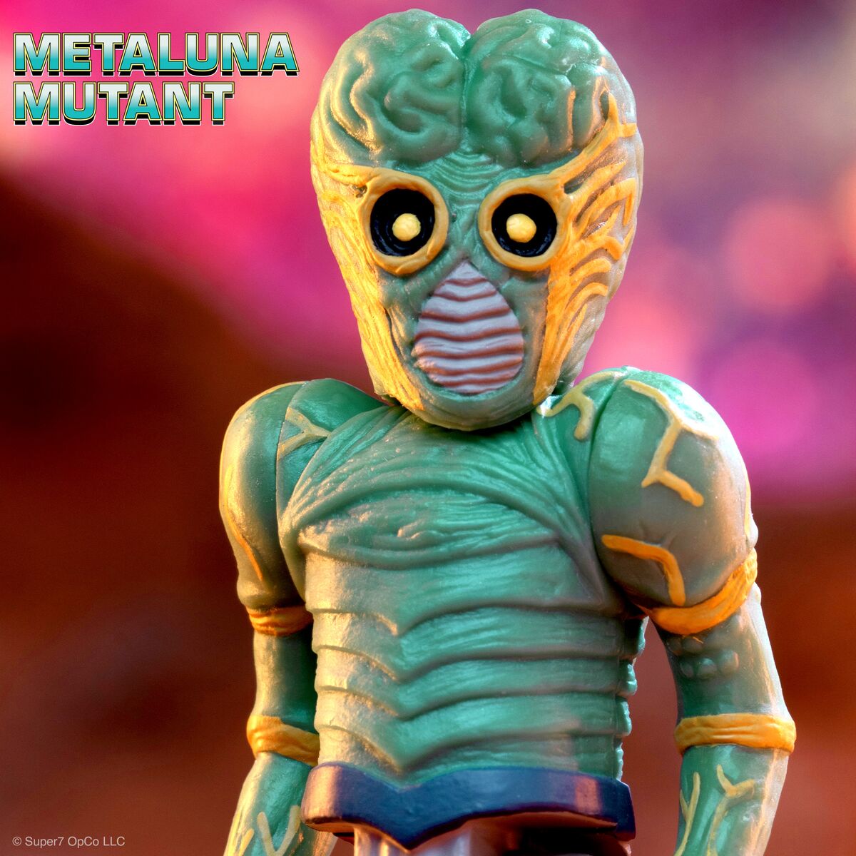 Close up of a green alien action figure with a brainlike head and large yellow eyes from the Metaluna Mutant line