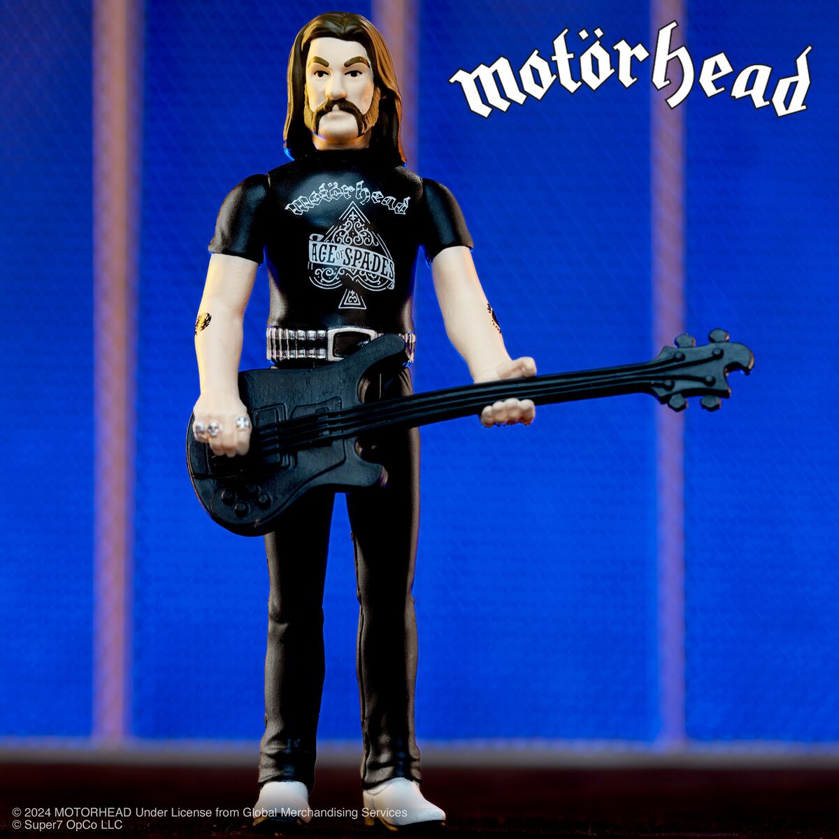 Motorhead figurine dressed in black gear holding a black bass guitar against a blue backdrop with the Motorhead logo.