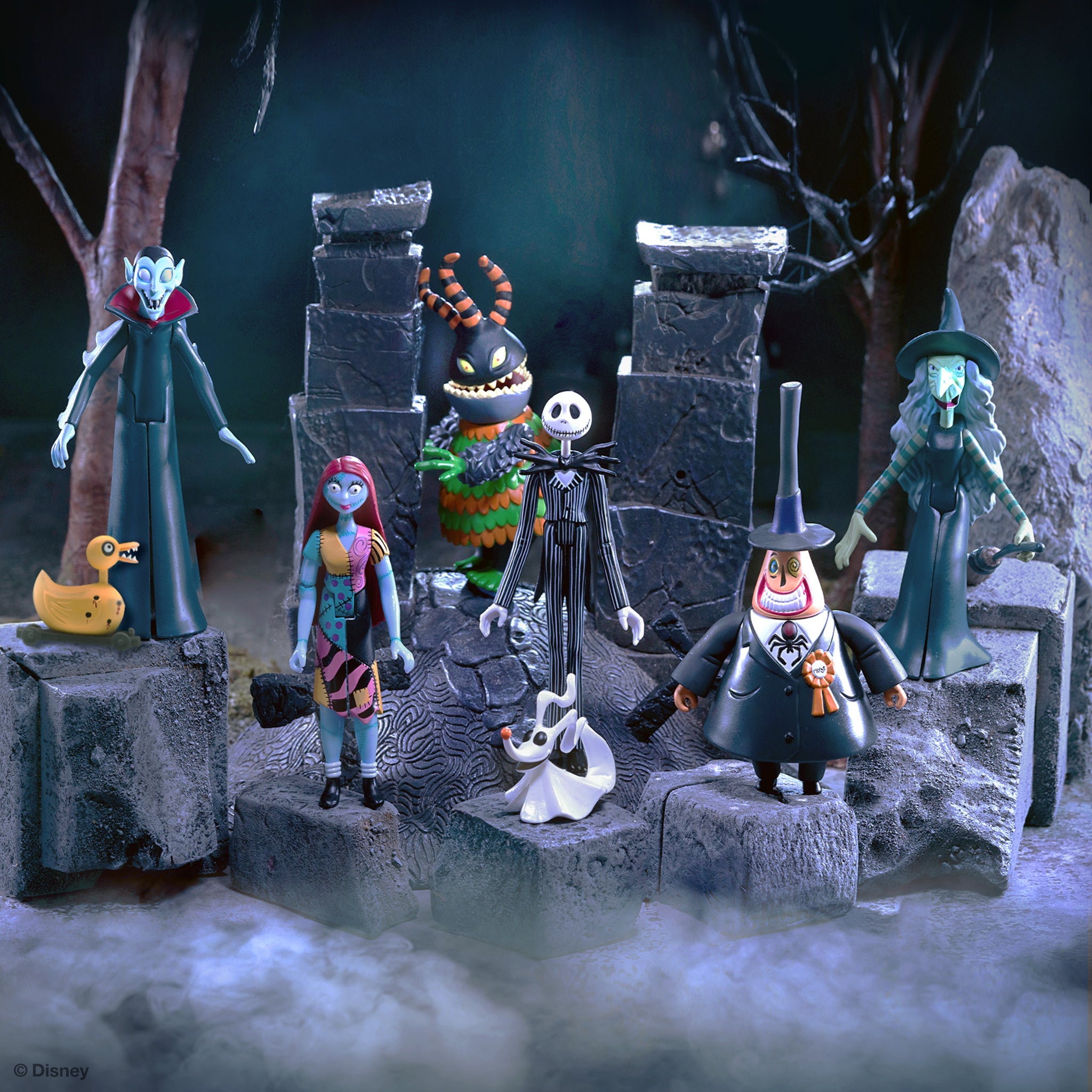Collectible figurines from Tim Burton's The Nightmare Before Christmas posed on a rocky diorama.