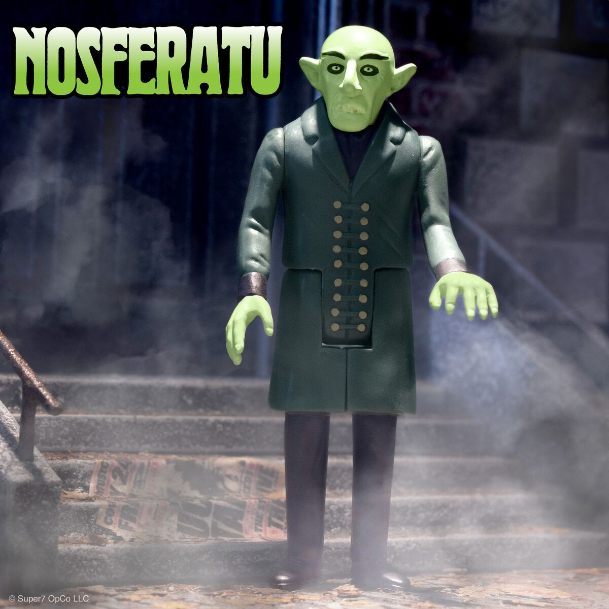 Nosferatu vampire action figure on steps in a dark smoky scene with a green face and long coat