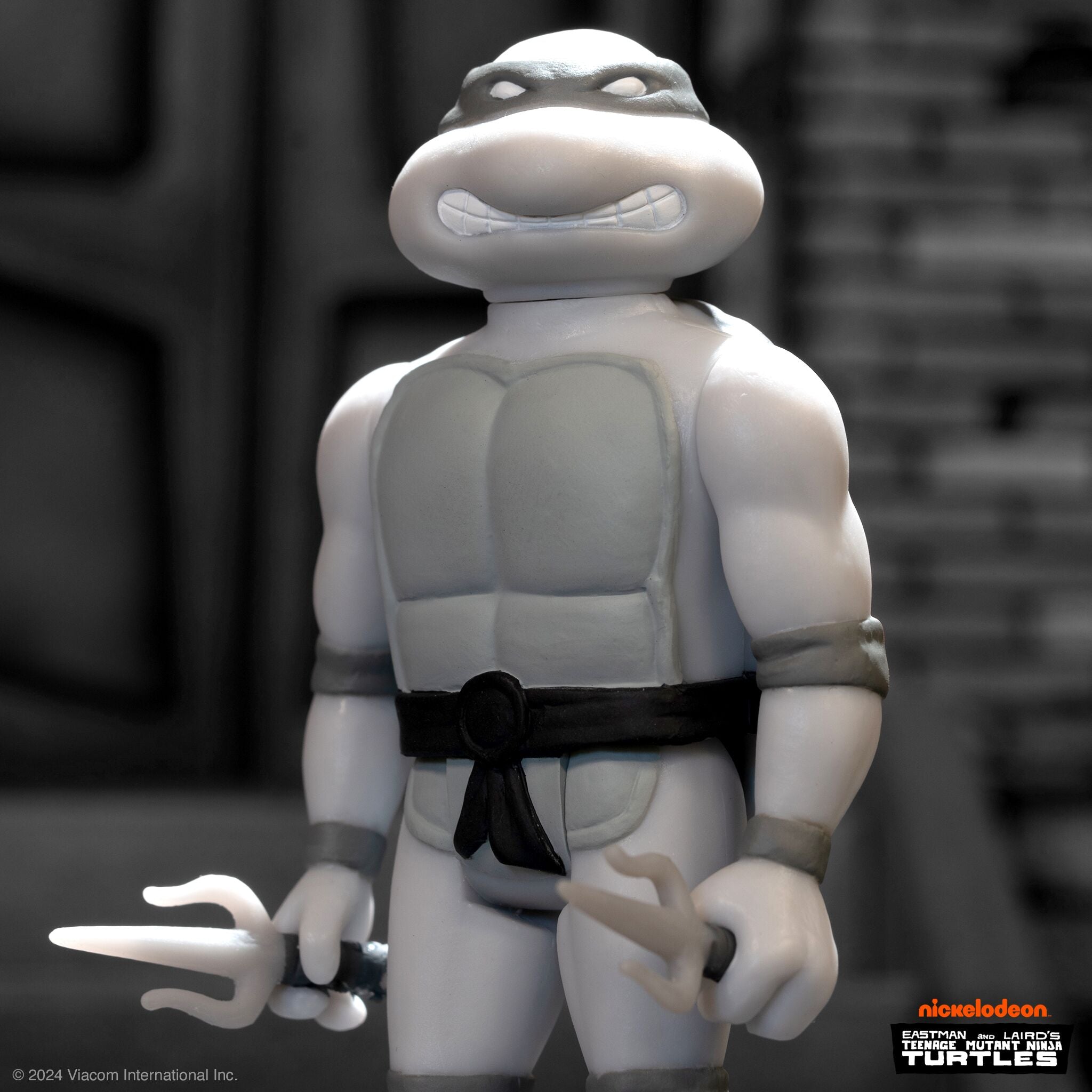 White Teenage Mutant Ninja Turtles figure in a grayscale close-up with a black belt