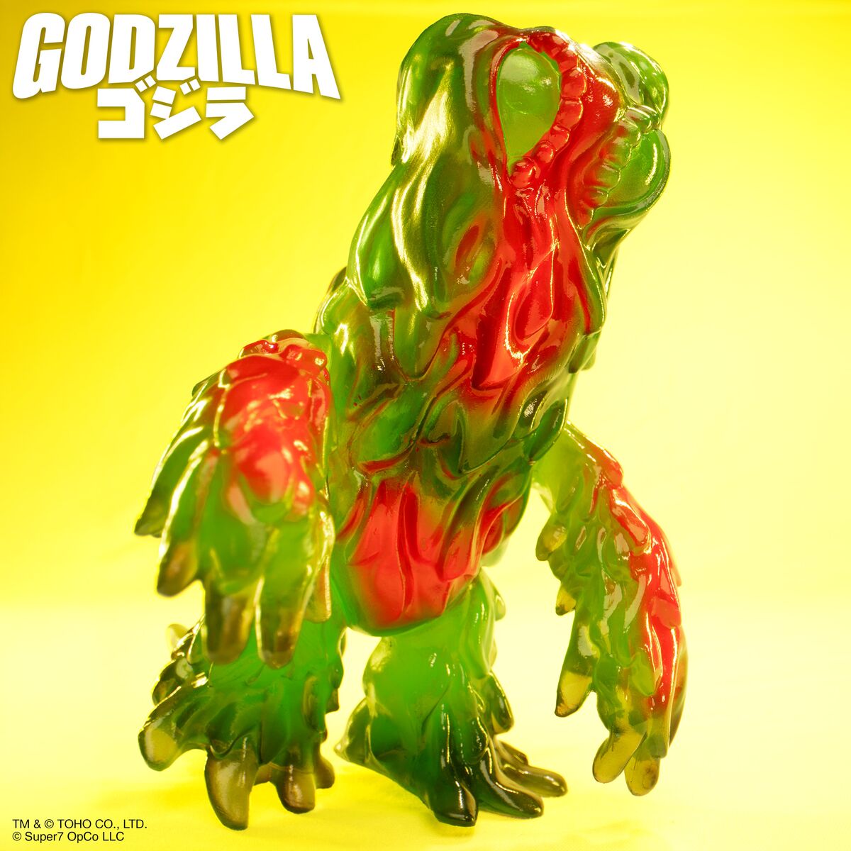 Colorful translucent Hedorah kaiju figure set against a bright yellow background with Godzilla branding.