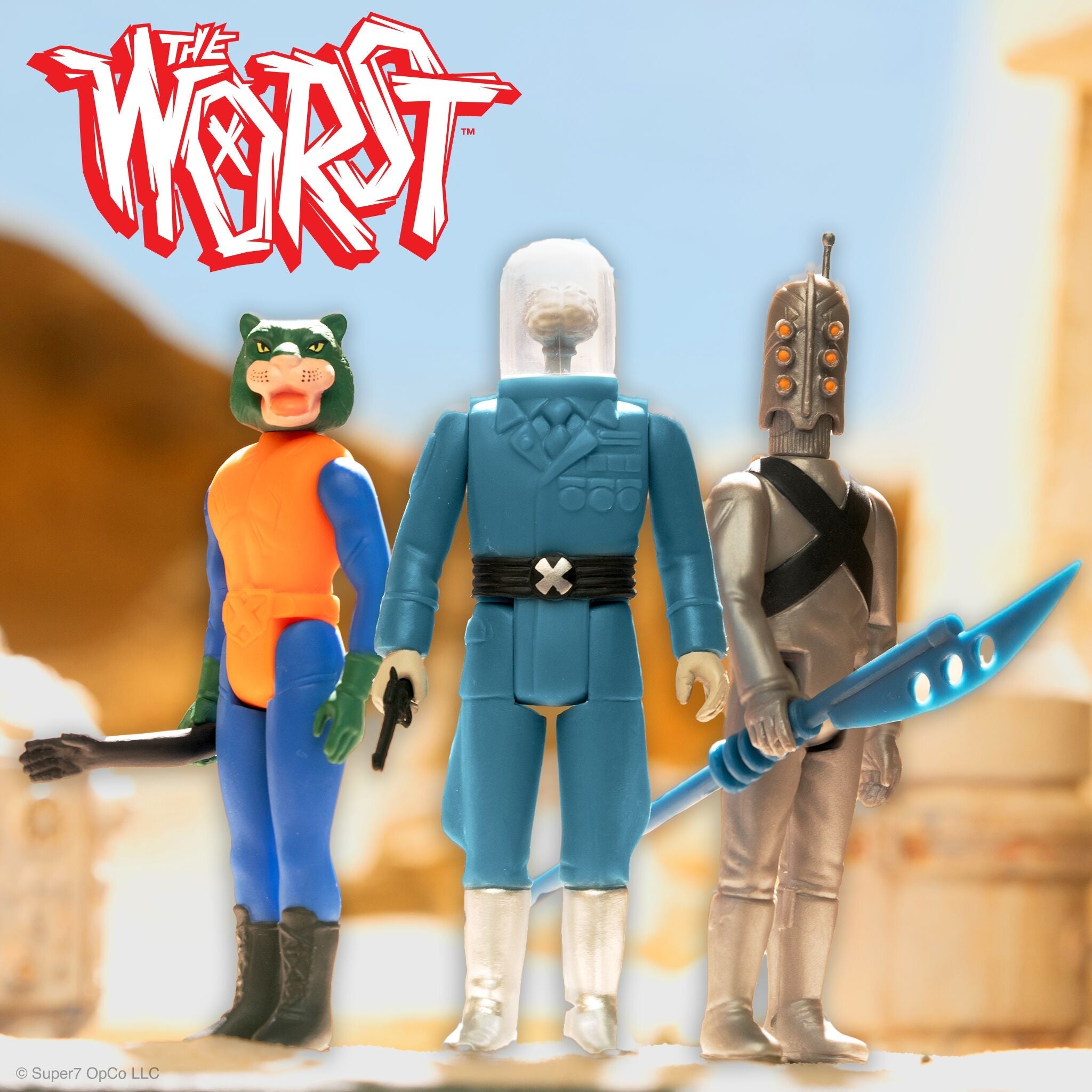 Super7 Originals figures lineup against a pale blue background; center blue armored character flanked by a green and orange figure on the left and a silver armored figure on the right with a blue weapon visible.