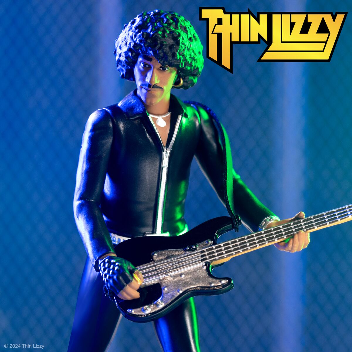 Thin Lizzy action figure in a black leather suit playing a bass guitar with the band's yellow logo in the corner