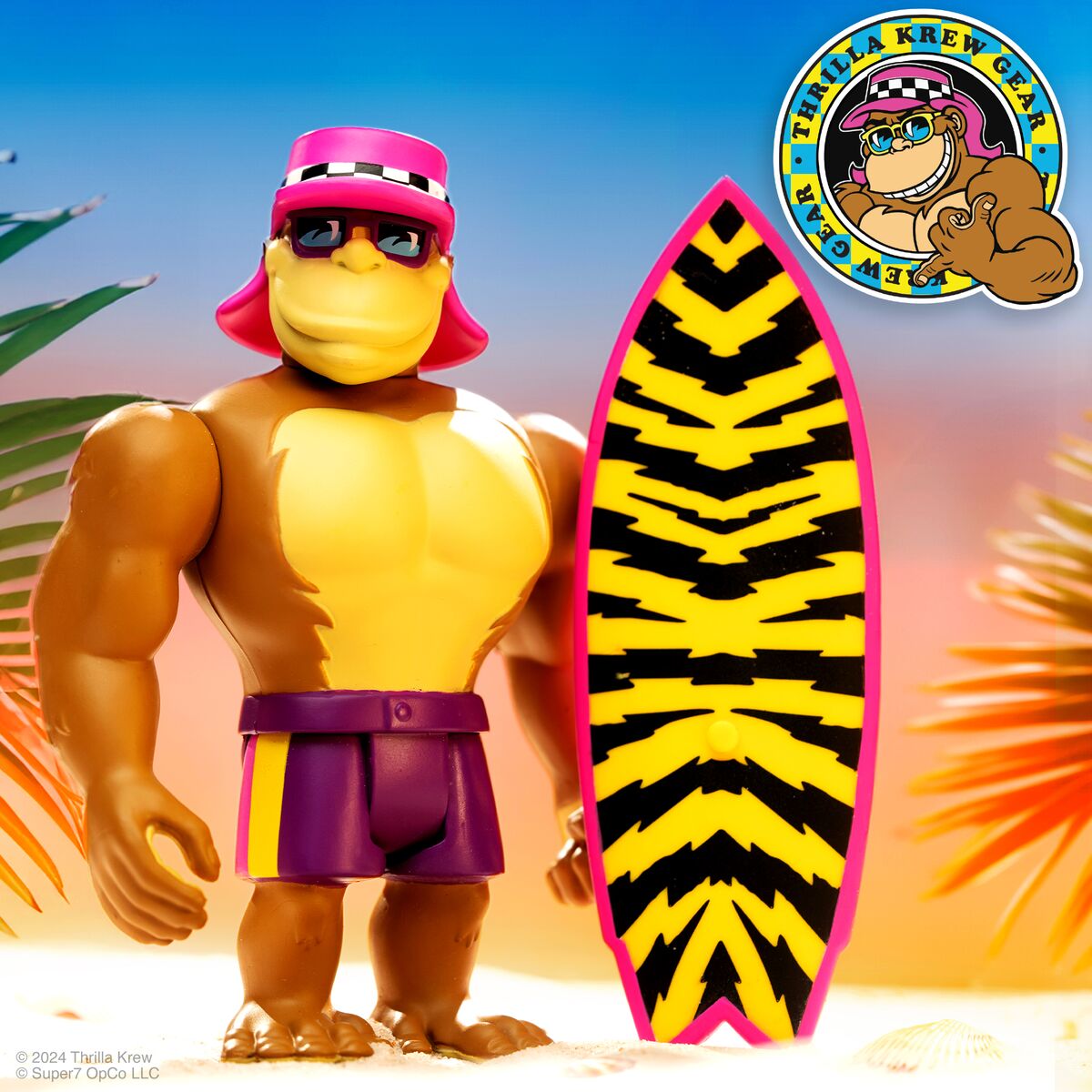 Thrilla Krew action figure with pink cap and sunglasses beside a neon striped surfboard on a sunny beach.
