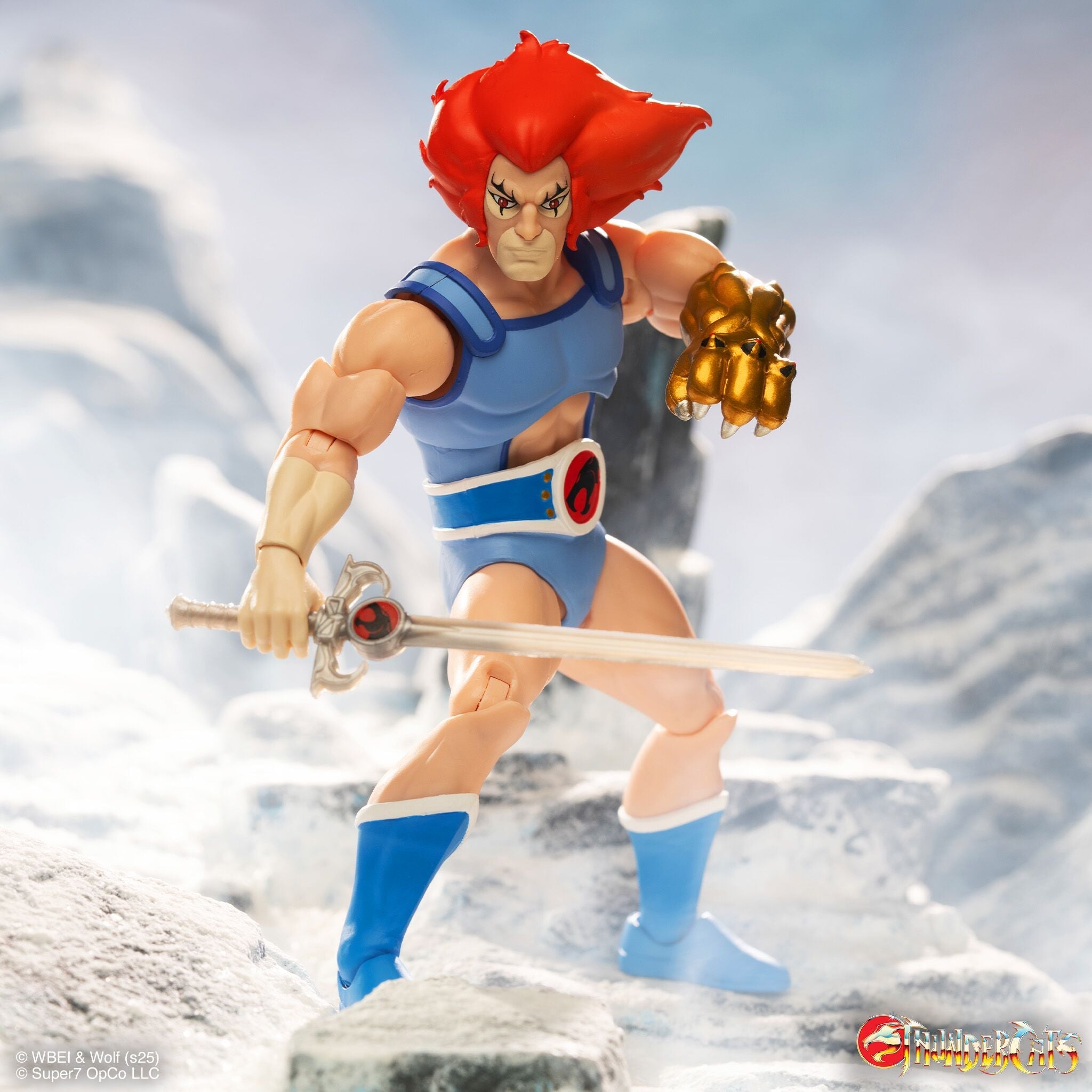 80s action figure quartet on a rocky platform including a red armored fighter an armored warrior a masked villain and a blue clad ally.