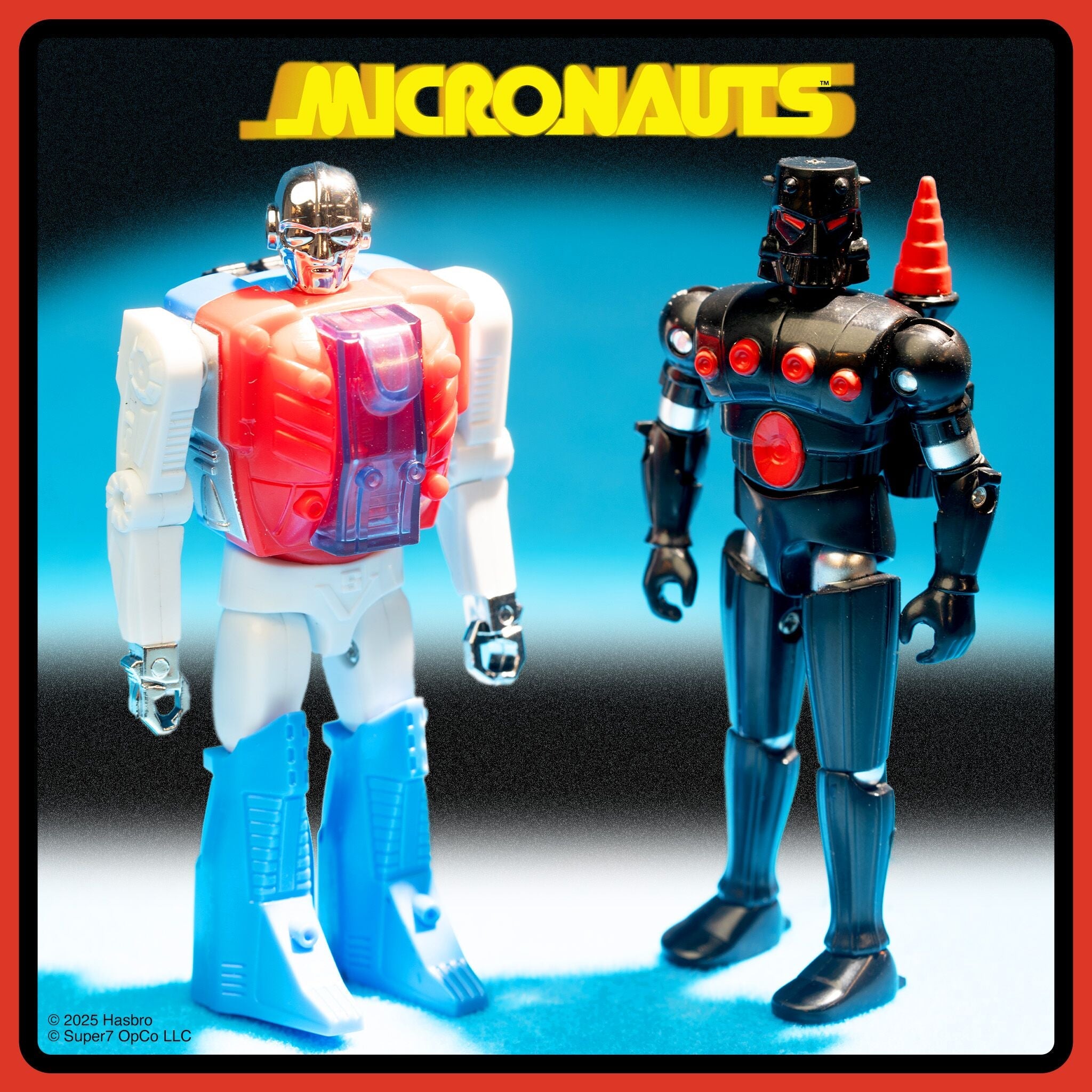 Two vintage Micronauts action figures standing on a blue surface with retro packaging in the foreground