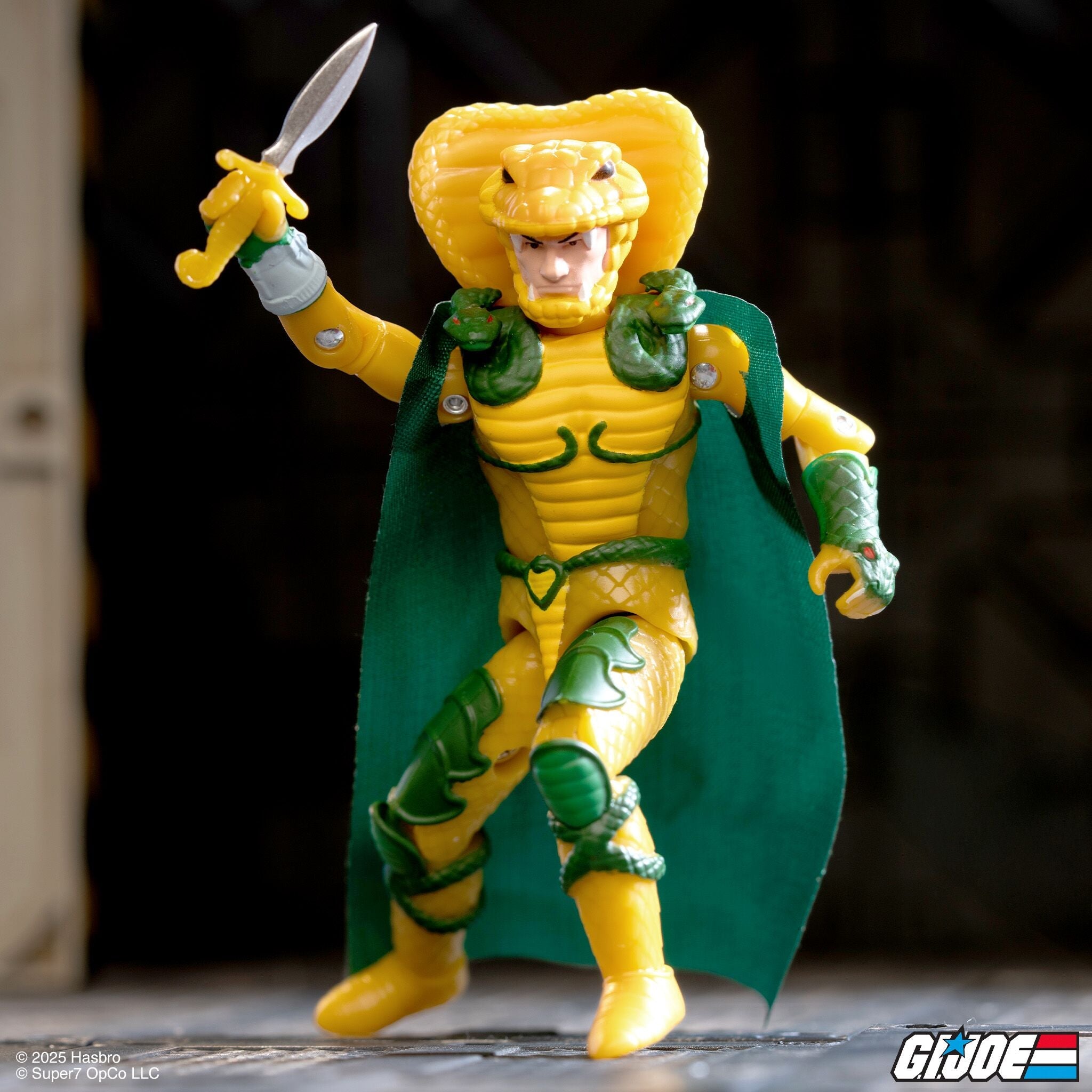 Yellow dragon knight action figure posed with a raised sword and a green cape