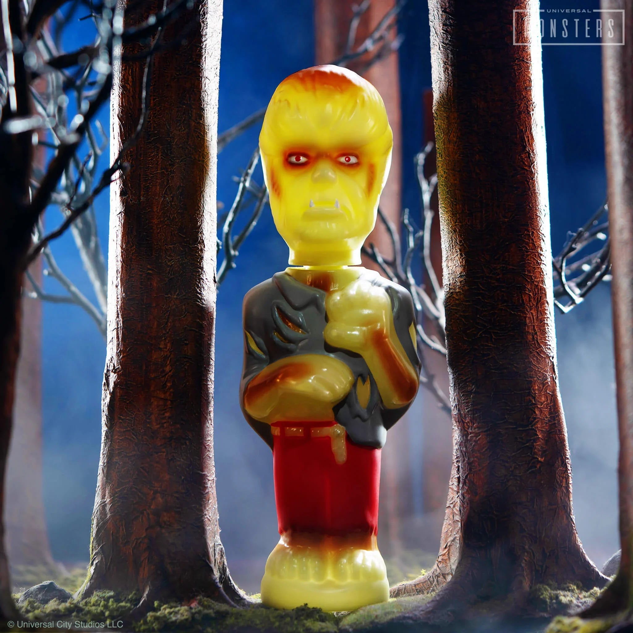 Yellow zombie action figure from the Super Soapies collection stands between tree trunks in a forest setting.