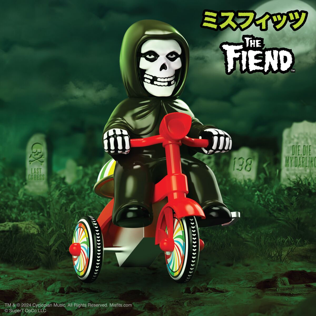 Skeleton figure in a hood rides a red tricycle through an eerie graveyard in the Super Cycles collection.