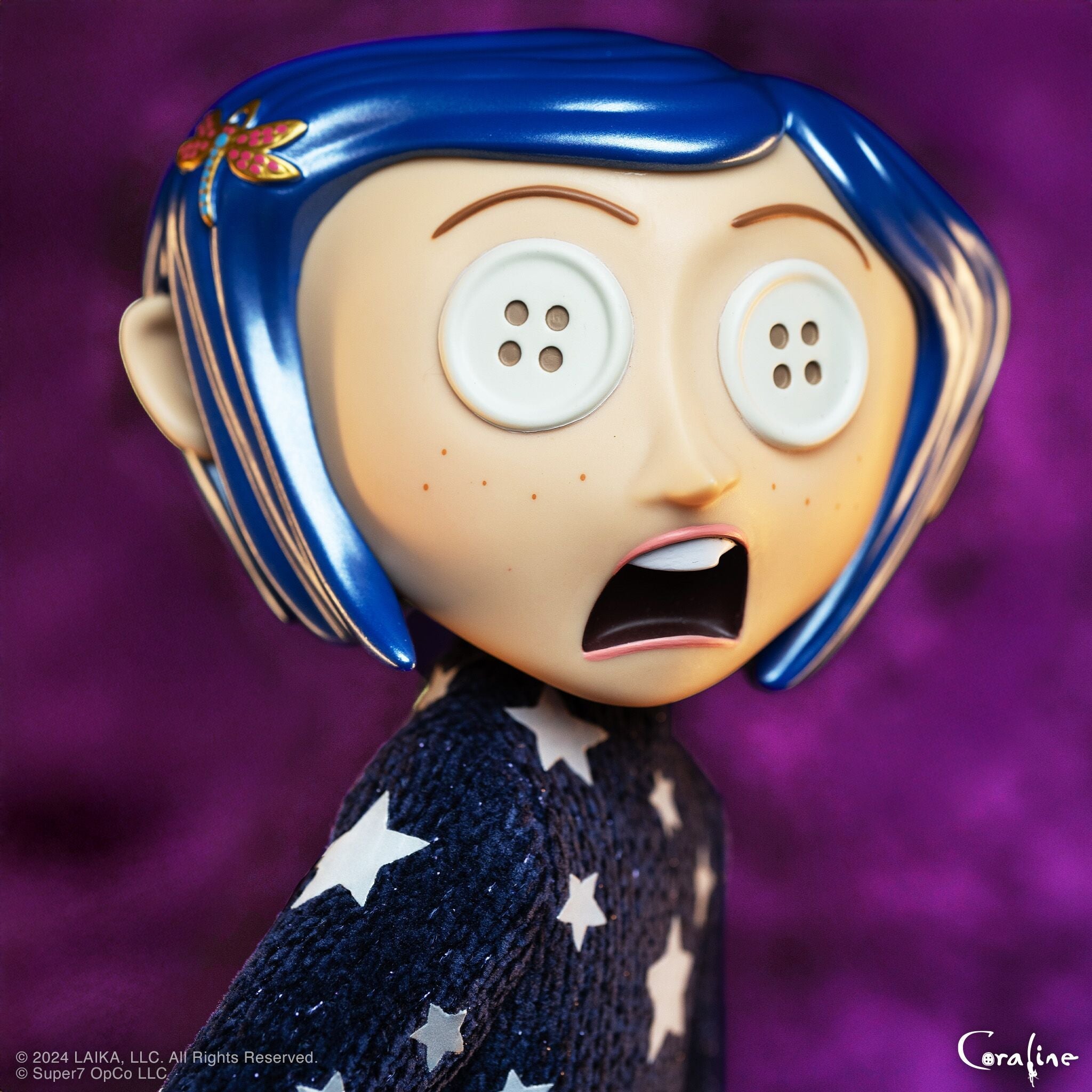 Close-up of Coraline with blue hair and a pink butterfly clip against a purple background