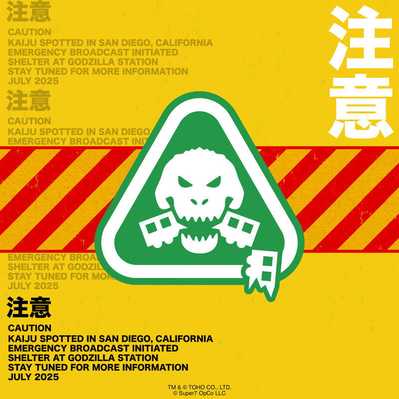 Bright yellow caution poster with red diagonal hazard stripes and a green skull warning sign for Godzilla Station