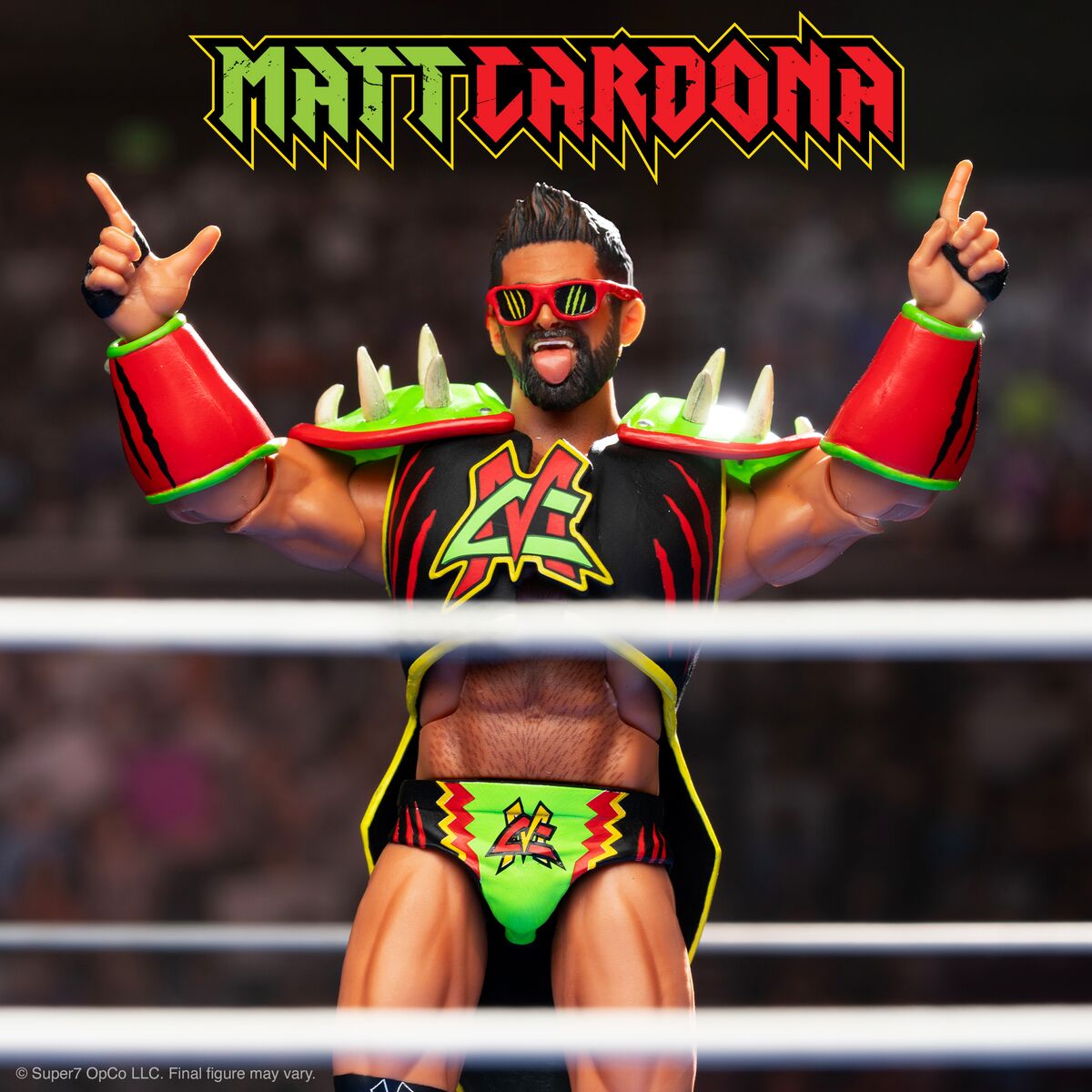 Matt Cardona action figure in neon green and red ring gear raising both arms in a wrestling ring.