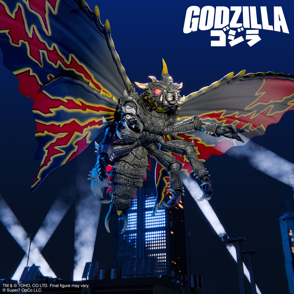 Godzilla winged kaiju figure with fiery wings soars above a city stage and bright lights.