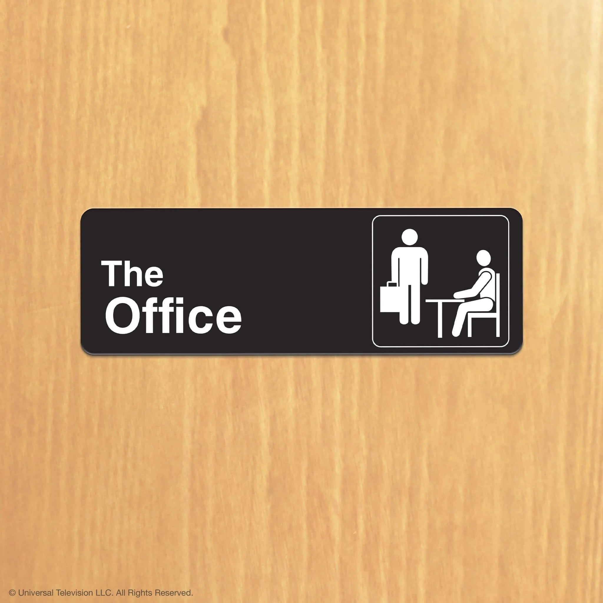 The Office collection sign black plaque with The Office text and white icons on a wood background