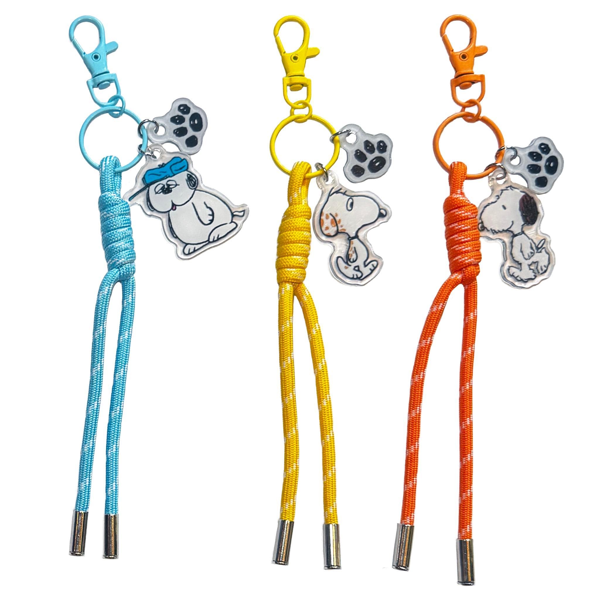 Peanuts Bag Charm Blind Box Wave 01 Siblings set with Snoopy and paw print charms on blue yellow and orange cords