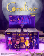Coraline Blind Box Wave 01 promotional image featuring a blue haired figure and a black cat beside stacked boxes
