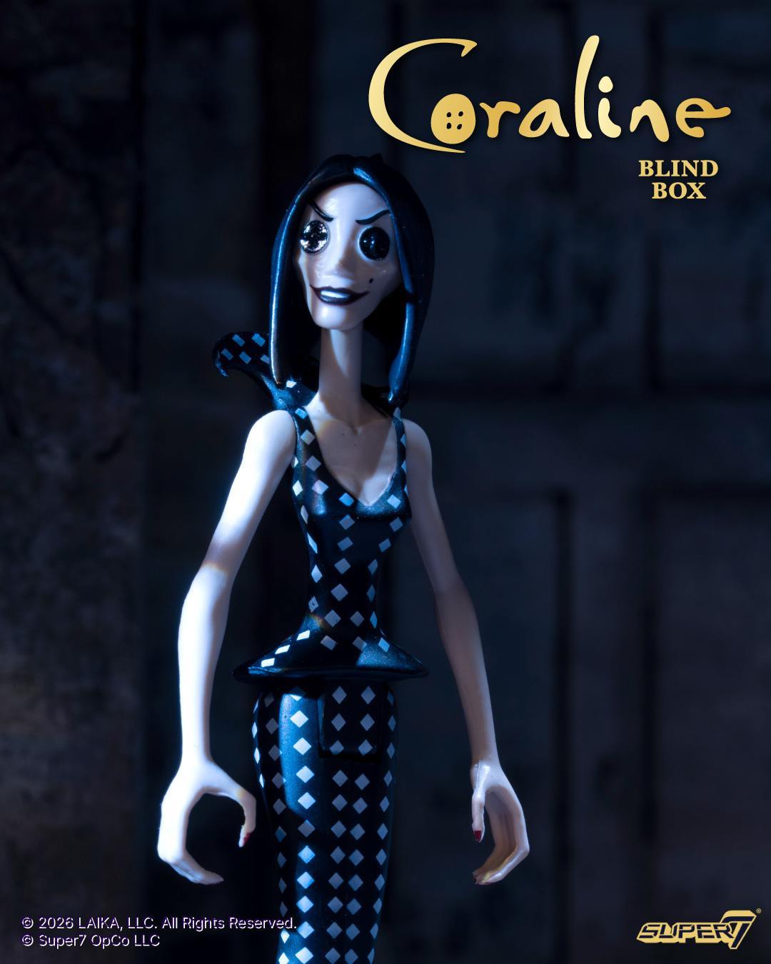 Coraline ReAction Wave 01 figure in a black and white diamond dress stands in moody blue lighting.