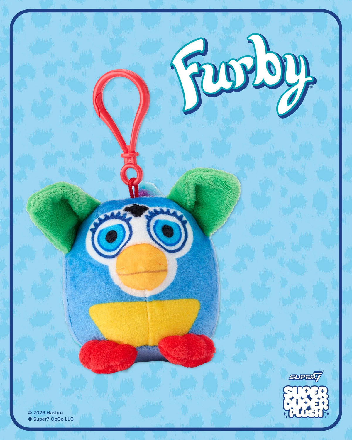 Front view of blue Furby plush with green ears and red feet on a white background.