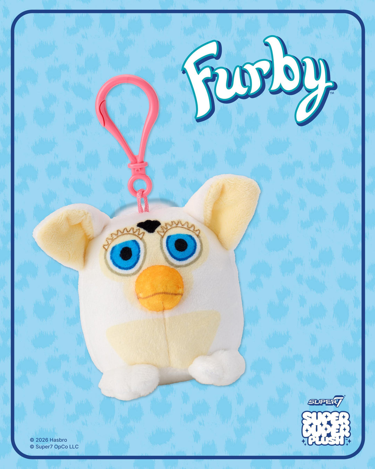 Pink hanging clip on blue Furby packaging with logo