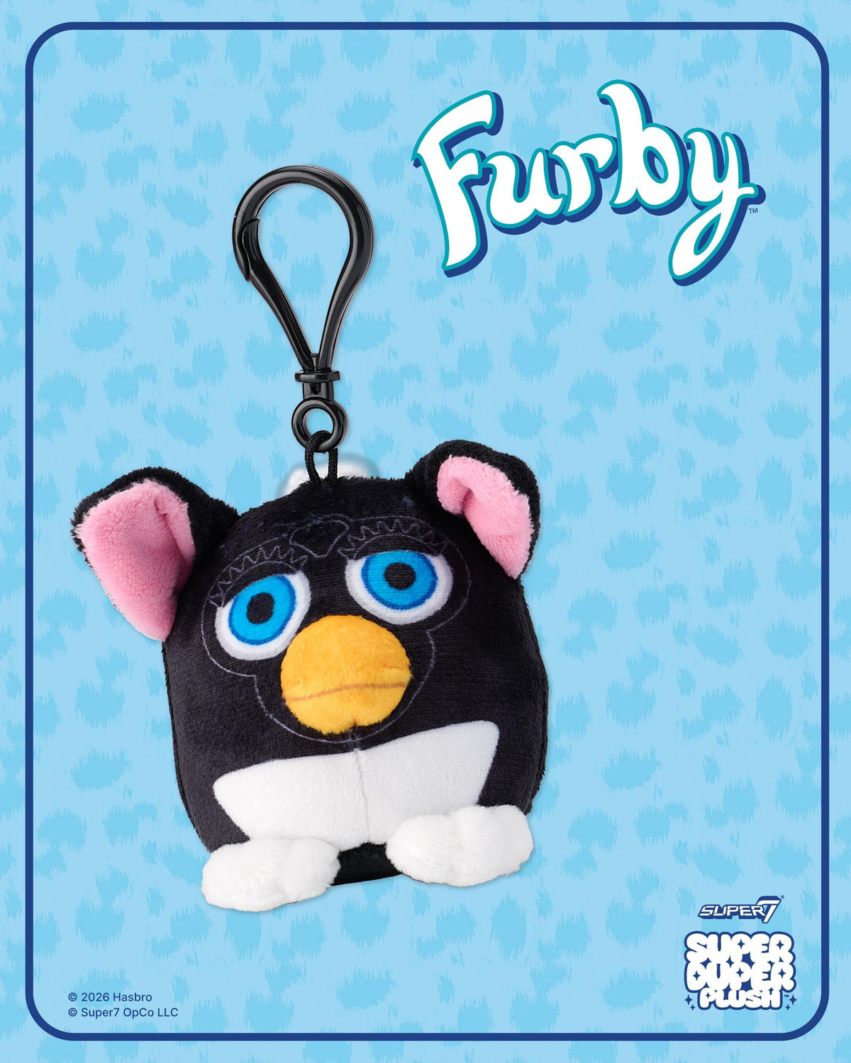 Furby Super Duper Plush blind box artwork featuring a black Furby with pink ears against a blue patterned background.
